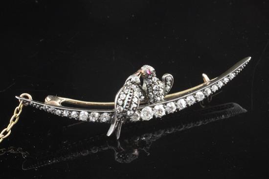 A Victorian gold and silver, old and rose cut diamond set crescent brooch surmounted with two birds, 2.25in.